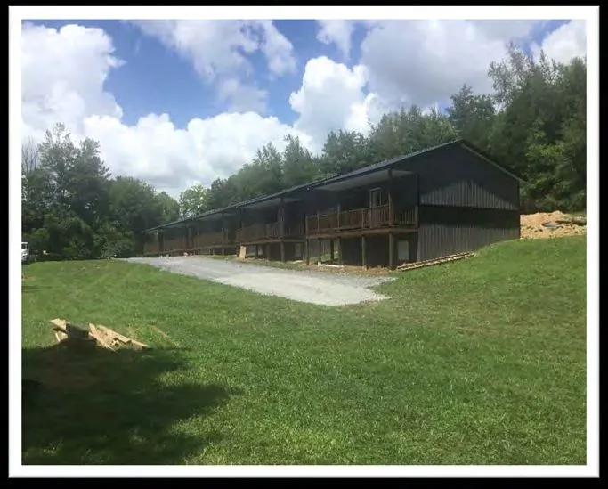 Riverside Resorts — gravel base prepared for mini-golf in front of the cabins